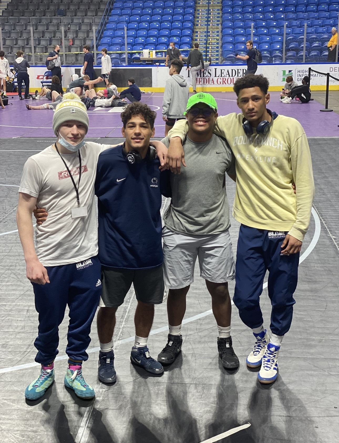 Four wrestlers at a tournament arena