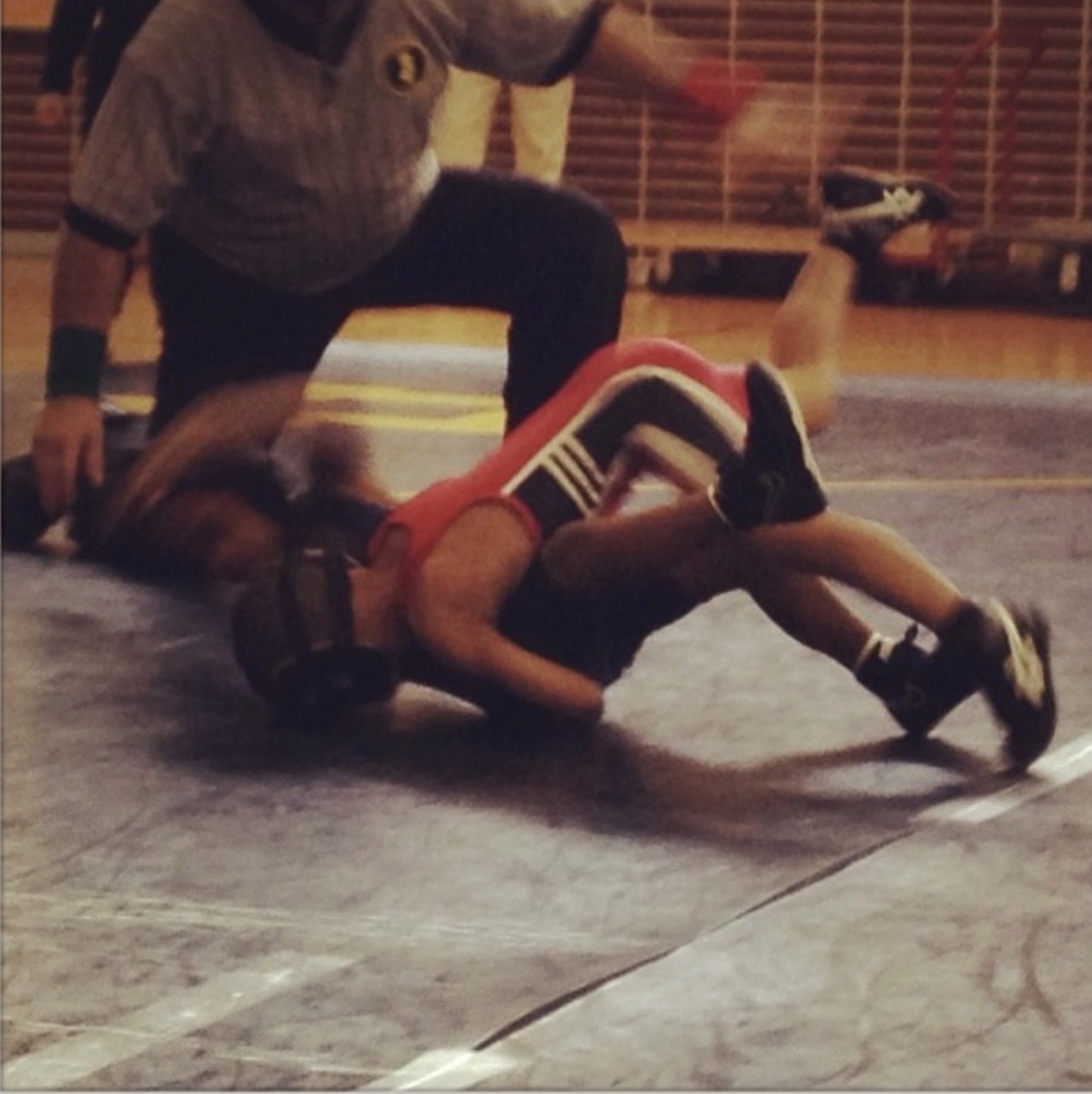 Young Lorenzo pinning an opponent as a kid